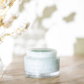 Pretty Farm Girl Blue Beauty tallow face cream, open glass jar on a wooden table