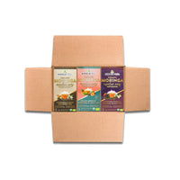 An open box reveals three boxes of Miracle Trees Energy Moringa Tea in the Mighty Bundle, featuring delightful flavors: Moringa & Chai, Peach & Apricot, and Turmeric & Black Pepper—a perfect superfood energy boost and coffee alternative.