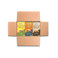 An open cardboard box unveils three vibrant boxes of Miracle Trees Energy Moringa Tea, Oomph Bundle, featuring flavors: Lemon & Ginger, Passionfruit, and Chai. Enjoy an organic energy boost with moringa superfood benefits as a healthy coffee alternative.