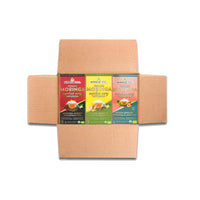An open cardboard box contains Miracle Trees Energy Moringa Tea, Spark Bundle with three vibrant flavors: Cherry & Chamomile, Ginger & Lemon, and Peach & Apricot. This organic tea is a great coffee alternative for an energy boost.